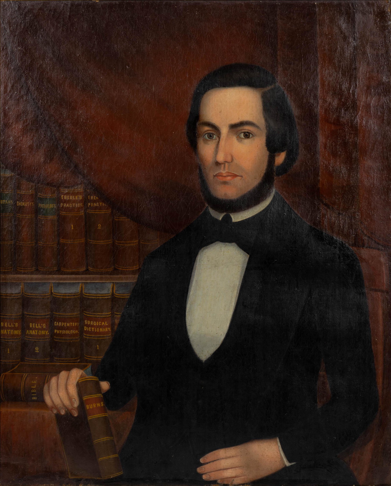 AMERICAN SCHOOL (19TH CENTURY) FOLK ART PORTRAIT OF A DOCTOR: AMERICAN SCHOOL (19TH CENTURY) FOLK ART PORTRAIT OF A DOCTOR, oil on canvas retaining likely original stretcher, waist-length depiction of a handsome bearded figure seated in an interior, the red