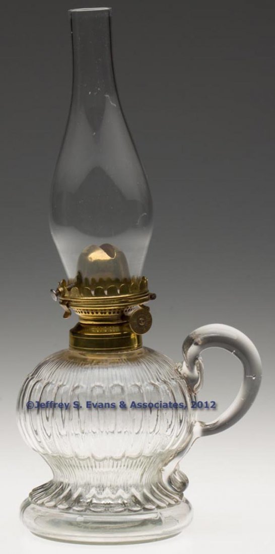 E. MILLER NO. 0 HINGED LIP BURNER: E. MILLER NO. 0 HINGED LIP BURNER, thumbwheel marked "E. MILLER CO / PAT MADE IN U. S. A.", non-period lip chimney. Fitted on a colorless Melon with Fine Rib footed finger lamp, applied handle, No. 1 