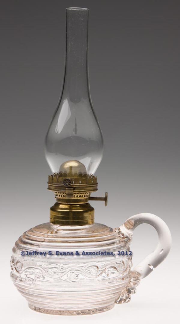 E. MILLER NO. 0 HINGED LIP BURNER: E. MILLER NO. 0 HINGED LIP BURNER, thumbwheel marked "E MILLER & CO. PAT. JUL 21 63", non-period lip chimney. Fitted on a colorless Fine and Rib finger lamp, applied handle, No. 1 fine line collar. Th