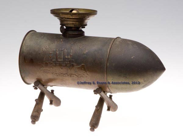 ADMIRAL DEWEY'S BULLET / SHELL STAND LAMP: ADMIRAL DEWEY'S BULLET / SHELL STAND LAMP, copper shell casing with nickel-plated brass "projectile", crossed cannon feet, shell casing is embossed with an image of the Maine and "ADMIRAL DEWEY'S LAMP