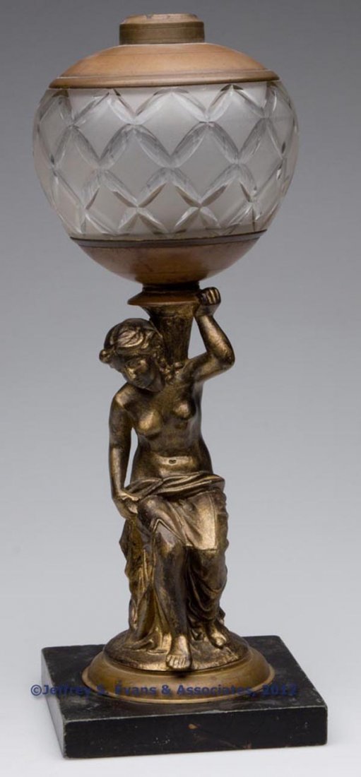 J. F. IDEN FIGURAL STEM STAND LAMP: J. F. IDEN FIGURAL STEM STAND LAMP, colorless font with frosted finish and cut petals, font base embossed "IDEN & CO N. Y.", spelter stem of lady holding urn with later bronze finish, mounted on a sla