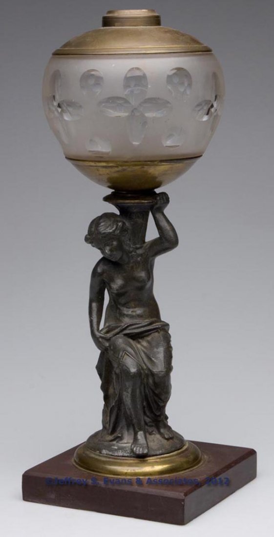 J. F. IDEN FIGURAL STEM STAND LAMP: J. F. IDEN FIGURAL STEM STAND LAMP, colorless font with frosted finish and cut quatrefoils and punties, font base embossed "IDEN & CO N. Y.", spelter stem of lady holding urn and reverse with a slight
