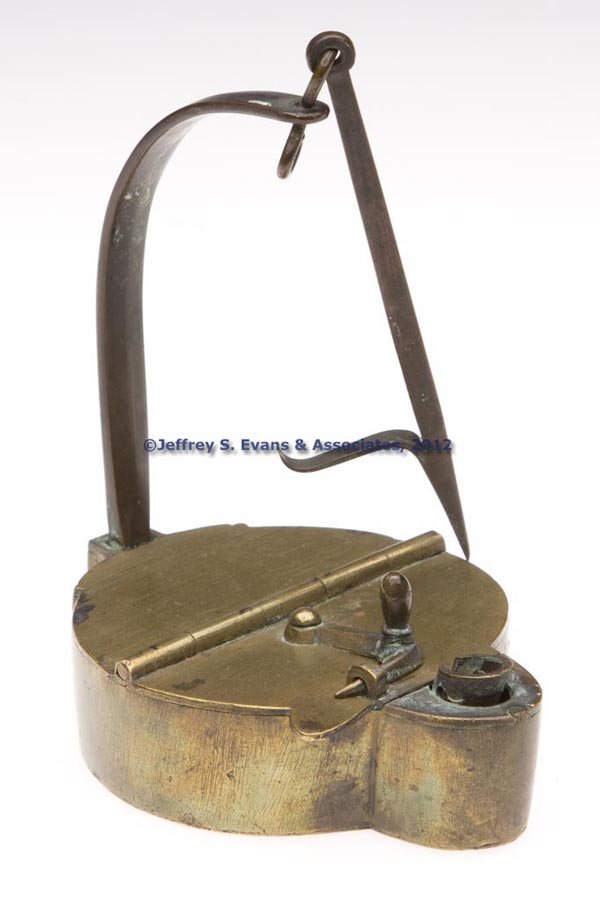 BRASS BETTY LAMP: BRASS BETTY LAMP, hinged cover with sliding latch and tab for opening, single wick support and hook. 19th century. 5" HOA. Provenance: Property of a New Jersey collector.