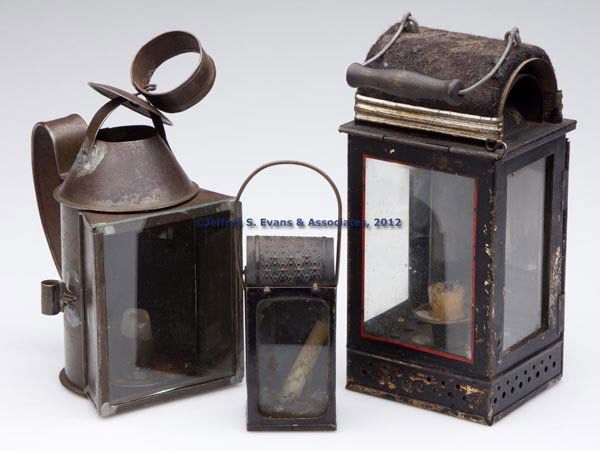 SHEET IRON CANDLE LANTERNS, LOT OF THREE: SHEET IRON CANDLE LANTERNS, LOT OF THREE, each fitted with a single socket, comprising two rectangular-form examples with bail handles and black paint, largest example with three glass panels with one