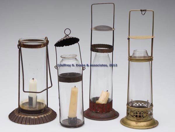 SHEET IRON AND BRASS CANDLE LANTERNS, LOT OF FOUR: SHEET IRON AND BRASS CANDLE LANTERNS, LOT OF FOUR, cylinder forms with handles, three period and one non-period colorless chimney/globes which vertically raise for maintenance, comprising three sheet