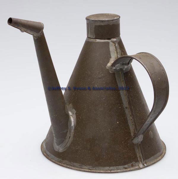 SHEET IRON LAMP FILLER: SHEET IRON LAMP FILLER, conical form with strap handle and removable cap. 19th century. 6 1/2" H, 6" D base. Provenance: The Phillip M. Sullivan estate collection.