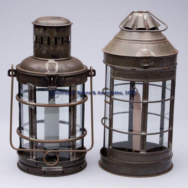 SHEET IRON CANDLE LANTERNS, LOT OF TWO: SHEET IRON CANDLE LANTERNS, LOT OF TWO, circular forms with bail handles and hinged covers, comprising one example with traces of black paint, fitted with five removable colorless glass panes with bra