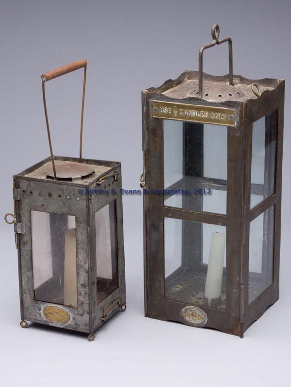 ENGLISH SHEET IRON FOLDING CANDLE LANTERNS, LOT OF: ENGLISH SHEET IRON FOLDING CANDLE LANTERNS, LOT OF TWO, square forms with bail handles, colorless panes including one fitted in a hinged frame, single socket holders, comprising a mica-pane example wi