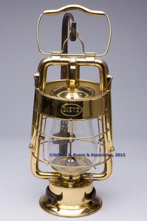 DIETZ "KING" FIRE DEPARTMENT BRASS HOT BLAST TUBUL: DIETZ "KING" FIRE DEPARTMENT BRASS HOT BLAST TUBULAR LANTERN WITH WROUGHT IRON BRACKET, polished, bail handle and apparatus hook, wind guard embossed "DIETZ" to each side and "PATENTED AUG. 27.07" to