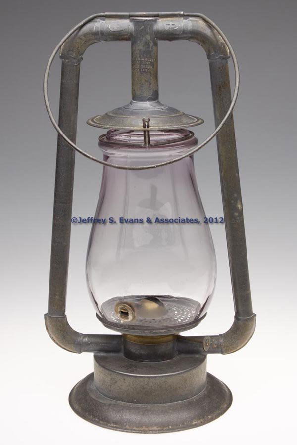 PATENTED SHEET IRON HOT BLAST TUBULAR LANTERN: PATENTED SHEET IRON HOT BLAST TUBULAR LANTERN, bail handle, tube marked "PAT'D APRIL 2, 1867 / MAY 28, 1867 / JANUARY 7, 1868. / MAY 4, 1869", colorless globe with lavender tint fitted with a brass an