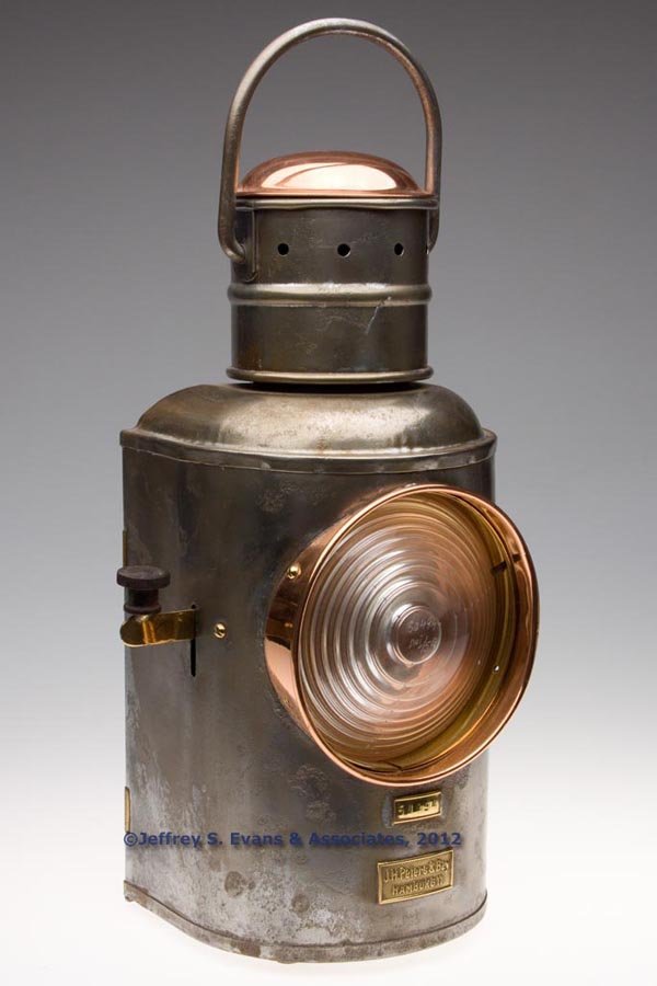 J. H. PETERS & BEY SHEET IRON, BRASS AND COPPER SI: J. H. PETERS & BEY SHEET IRON, BRASS AND COPPER SIGNAL MARINE LANTERN, polished, bail handle and hinged cap, flat back with hinged door, base with brass maker's plate marked "J. H. Peters & Bey HAMBUR