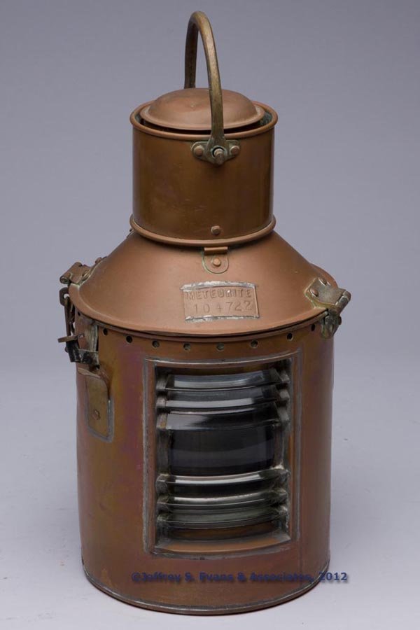 METEORITE BRASS AND COPPER MARINE LANTERN: METEORITE BRASS AND COPPER MARINE LANTERN, bail handle, hinged cover with maker's brass plate marked "METEORITE 104722", reverse with a strap handle, colorless fresnal lens, interior fitted with a shu