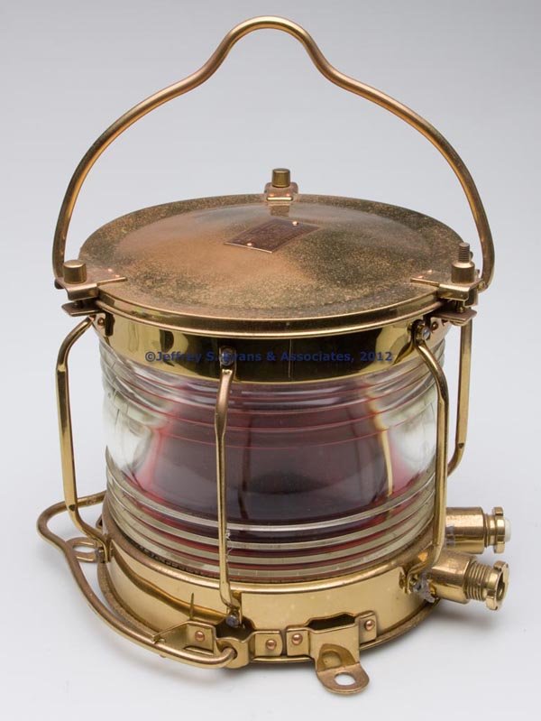 NIPPON SENTO BRASS ELECTRIC MARINE LIGHT: NIPPON SENTO BRASS ELECTRIC MARINE LIGHT, polished, bail handle and removable cover, maker's plate marked "RED LIGHT / NIPPON SENTO CO., LTD." and various other markings, base with three tie-down tabs