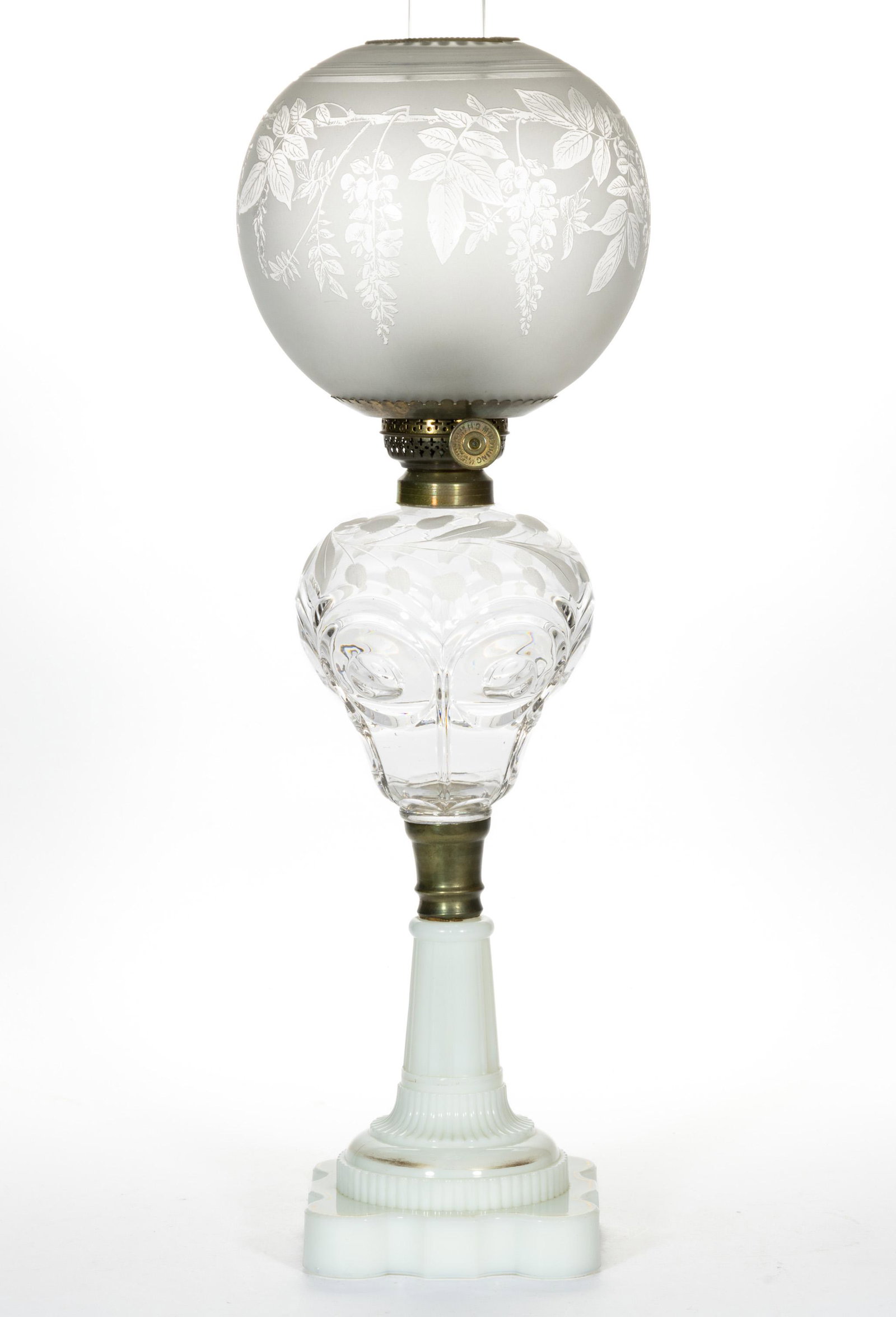 PANELED BULL'S EYE KEROSENE STAND LAMP: PANELED BULL'S EYE KEROSENE STAND LAMP, colorless pyriform font with engraved and roughed foliage pattern to the shoulder, opaque white No. 40 base with gilt decorated bands, underside of foo