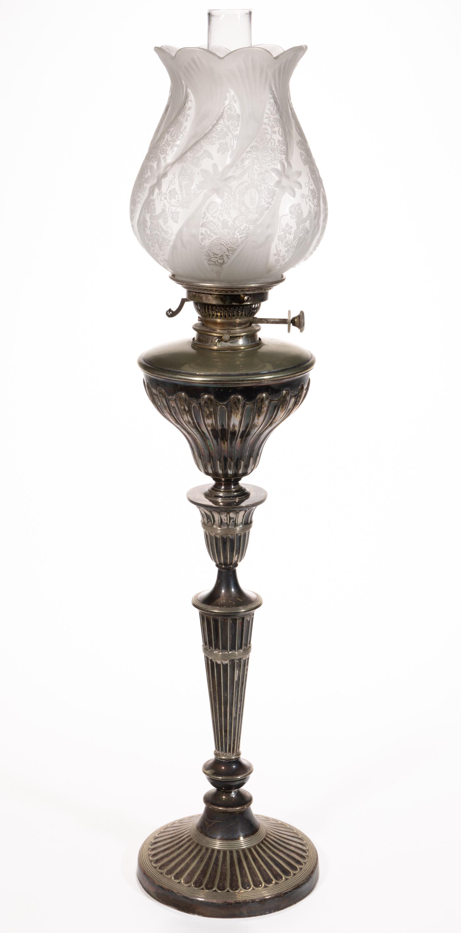 SILVER-PLATED BRASS RIBBED KEROSENE BANQUET LAMP: SILVER-PLATED BRASS RIBBED KEROSENE BANQUET LAMP, conical-form font with unpatterned shoulder, baluster-form stem and circular-form weighted foot, period collar. Fitted with a period setup comprising 