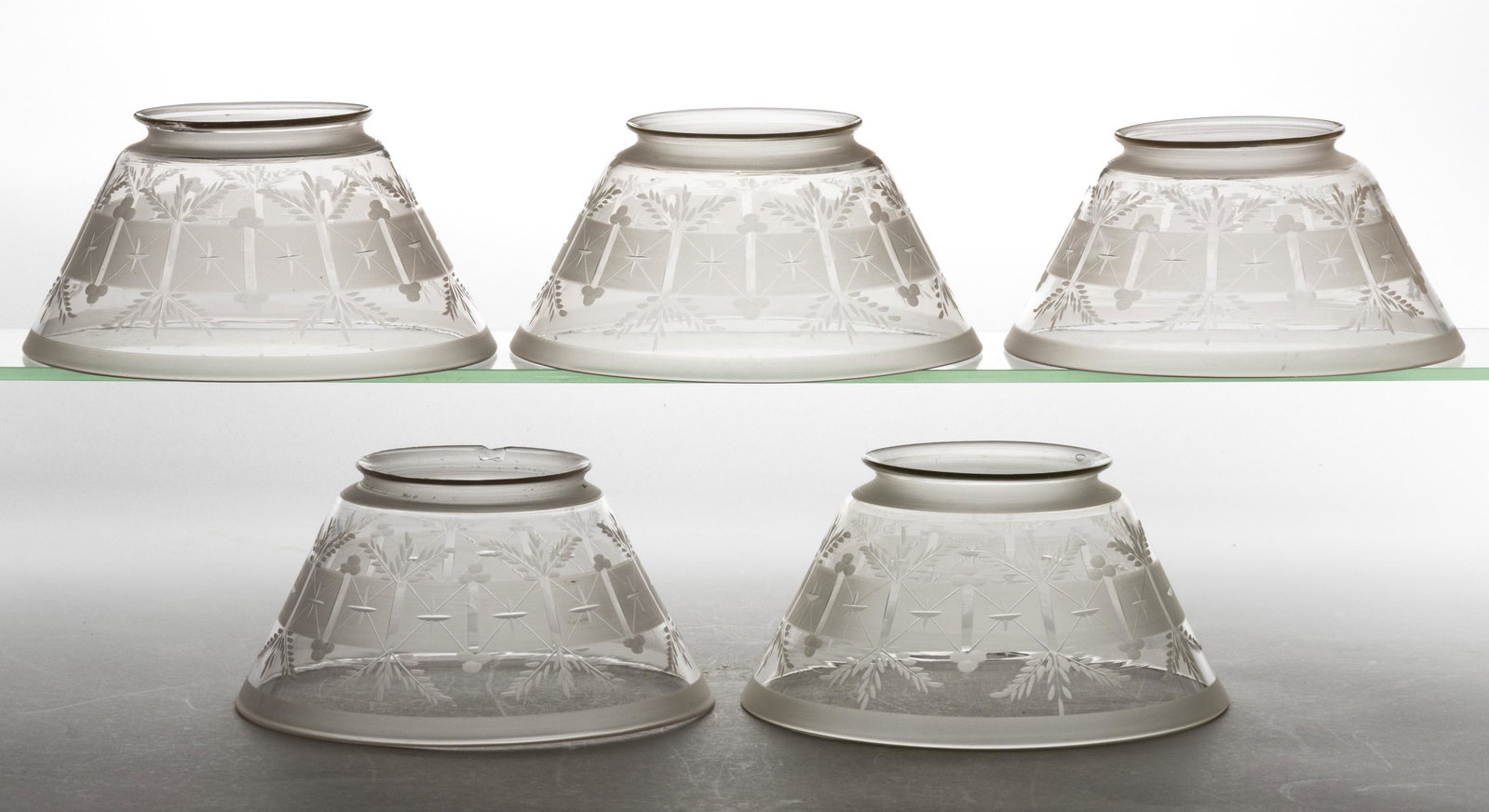 ENGRAVED AND ROUGHED SHADES, SET OF FIVE: ENGRAVED AND ROUGHED SHADES, SET OF FIVE, each conical form with roughed squares surrounded by wheat sheaves and berry clusters, squares with bisecting lines and cross. Circa 1875. 3 1/2" H, 7 3/