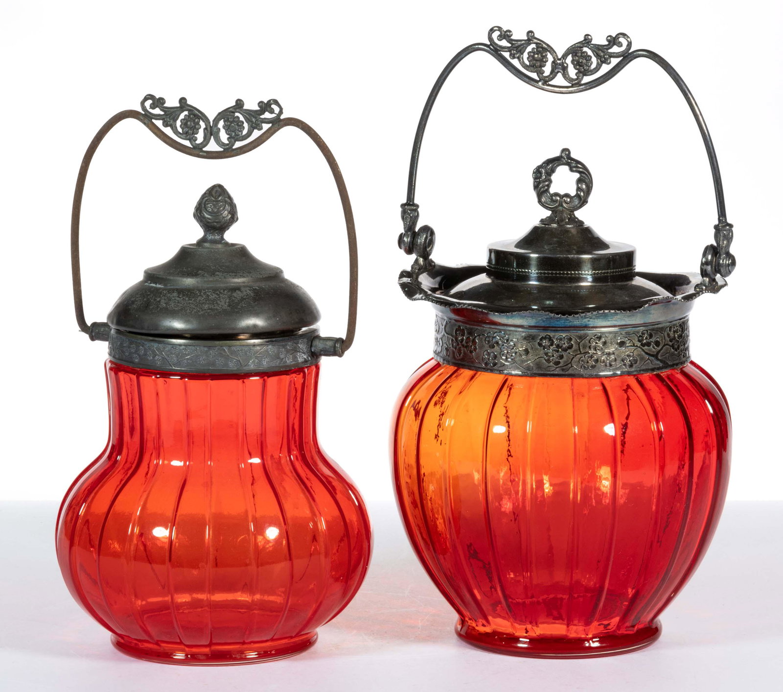 TORQUAY / CERISE (OMN) COVERED CRACKER / BISCUIT JARS, LOT OF TWO: TORQUAY / CERISE (OMN) COVERED CRACKER / BISCUIT JARS, LOT OF TWO, pigeon blood, comprising a baluster form and an urn form, each having a quadruple-plate mount having a bail handle and cove