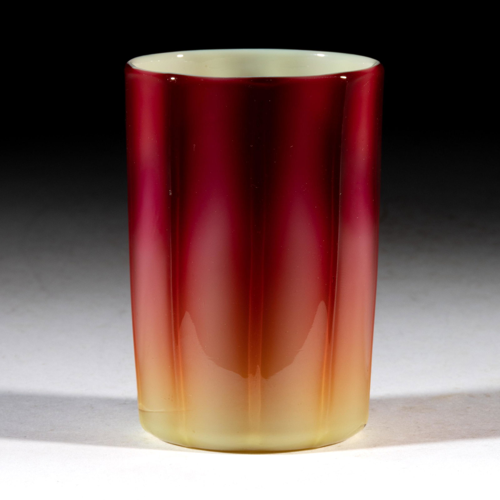 NEW ENGLAND PLATED AMBERINA TUMBLER: NEW ENGLAND PLATED AMBERINA TUMBLER, opal-cased deep maroon fuchsia to pale amber, cylindrical-form molded with nine vertical ribs, polished pontil mark. New England Glass Co. Circa 188