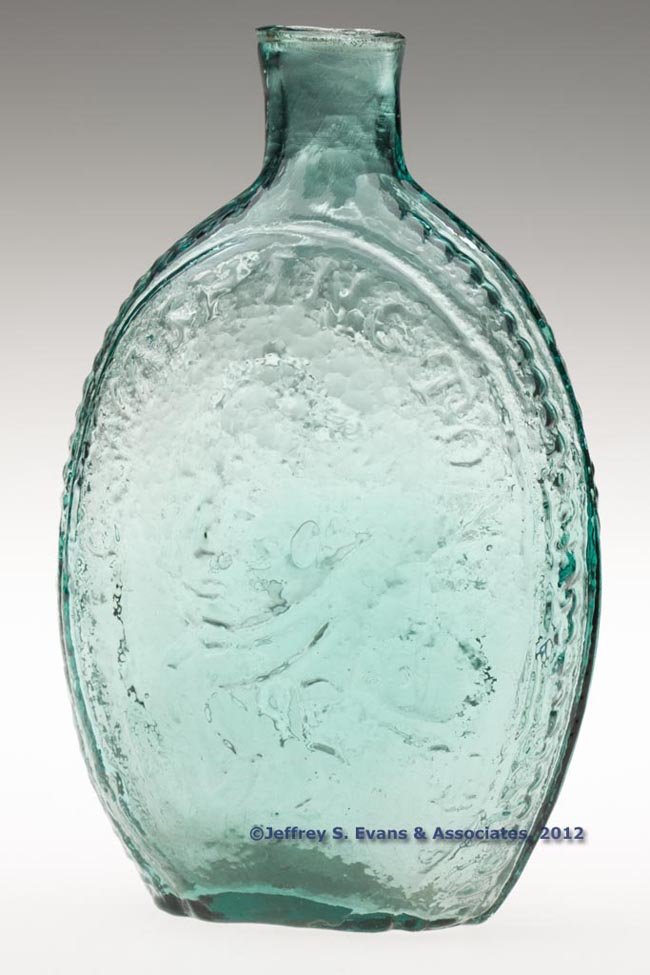 GI-10 WASHINGTON - EAGLE PORTRAIT FLASK: GI-10 WASHINGTON - EAGLE PORTRAIT FLASK, blue green, pint, embossed "G. WASHINGTON.", sheared mouth, rough pontil mark. Normal blurred impression. Unknown United States glass house. 1840-1860. 6 3/4" 