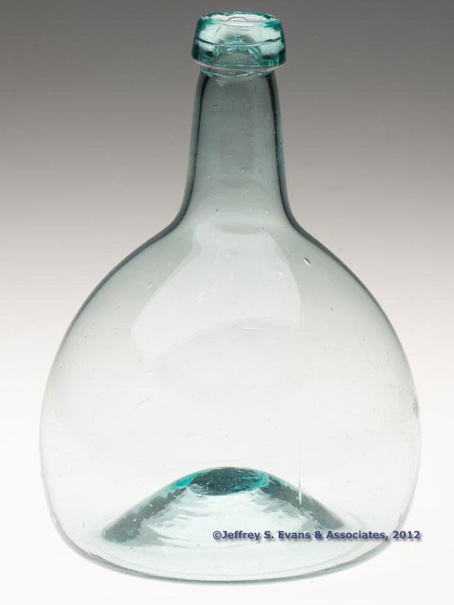 FREE-BLOWN BEEHIVE-FORM UTILITY BOTTLE: FREE-BLOWN BEEHIVE-FORM UTILITY BOTTLE, blue green, truncated body with a short neck and applied sloping mouth, kick-up base with rough pontil mark. United States, one of numerous glasshouses. 1800-18