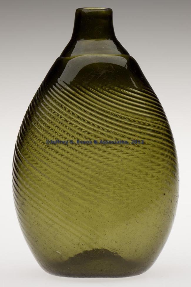 PATTERN-MOLDED PITKIN-TYPE FLASK: PATTERN-MOLDED PITKIN-TYPE FLASK, medium olive green, approximately one-half pint, flattened ovoid form, 36-ribs swirled to the left, short neck with a plain mouth, kick-up base with a rough pontil ma