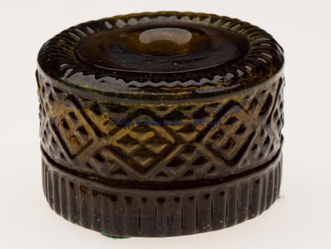 BLOWN-MOLDED GIII-29 INKWELL: BLOWN-MOLDED GIII-29 INKWELL, medium olive green with yellow overtones, plain base with rough pontil mark. Attributed to Keene, NH. 1815-1840. 1 1/2" H, 2 1/4" D. Literature: Covill, fig. 1221. Proven