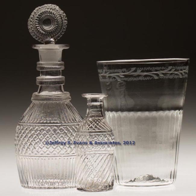 ASSORTED BLOWN-MOLDED TABLE ARTICLES, LOT OF TWO: ASSORTED BLOWN-MOLDED TABLE ARTICLES, LOT OF TWO, colorless, comprising a GII-18 pint decanter with stopper and a GII-13 caster bottle, each with a rough pontil mark. Along with a later engraved flip 