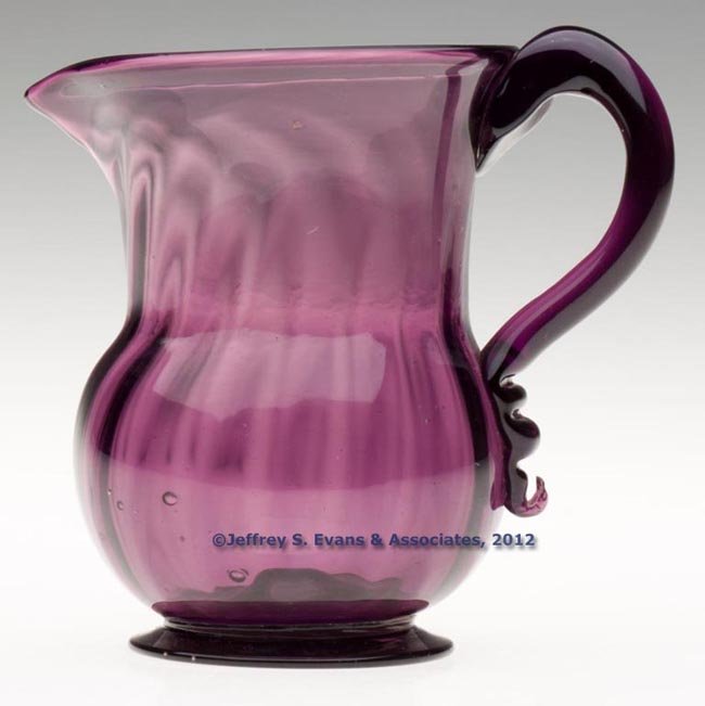 PATTERN-MOLDED CREAMER: PATTERN-MOLDED CREAMER, amethyst, compressed globular body with cylindrical neck, molded with 16 vertical ribs slightly swirled to the right at the plain rim, applied solid handle with delicate termin