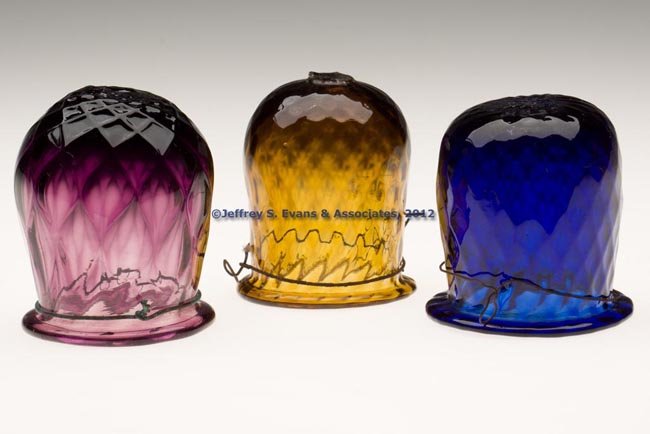 THREE PATTERN-MOLDED CHRISTMAS LIGHTS: THREE PATTERN-MOLDED CHRISTMAS LIGHTS, amethyst, deep cobalt blue and golden amber, each molded with expanded diamonds, folded rim and rough pontil mark, wire hangers. 1830-1870. 2 3/4" to 3" H. Prove