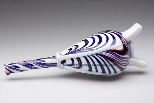 FREE-BLOWN MARBRIE LOOP DECORATED BELLOWS WHIMSY: FREE-BLOWN MARBRIE LOOP DECORATED BELLOWS WHIMSY, opal with four groups of red and blue swirled loopings, flattened chestnut form with elongated neck and tooled mouth, applied rings, rigaree straps an