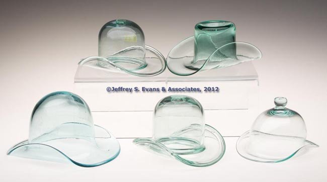 ASSORTED FREE-BLOWN HAT WHIMSIES, LOT OF FIVE: ASSORTED FREE-BLOWN HAT WHIMSIES, LOT OF FIVE, light green and bluish aquamarine, two with folded rim, one made from a bottle, each with rough pontil mark. 19th and 20th centuries. 3" to 4" H. Provena
