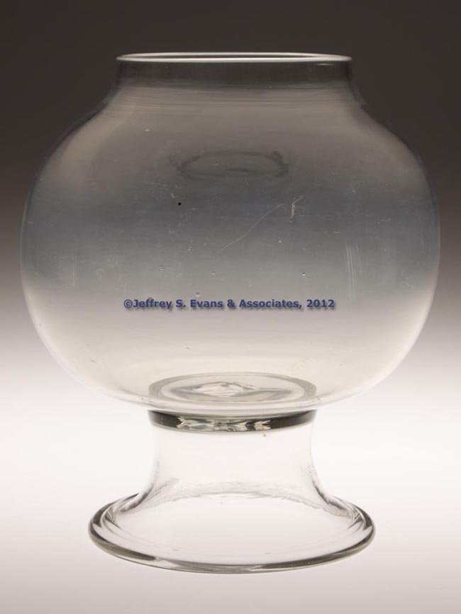 FREE-BLOWN FISH GLOBE ON FOOT: FREE-BLOWN FISH GLOBE ON FOOT, colorless, globular bowl with plain rim raised on a funnel foot with tooled rim, rough pontil mark. Bakewell, Pears & Co., Pittsburgh, and others. Circa 1875. 8 1/2" H, 