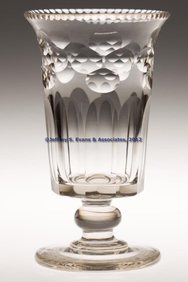 CUT QUATREFOIL AND PANEL CELERY GLASS: CUT QUATREFOIL AND PANEL CELERY GLASS, colorless with yellow tint, heavy deep bowl with notched rim, raised on an applied compressed-knop stem and plain foot with polished pontil mark. Possibly Pittsb