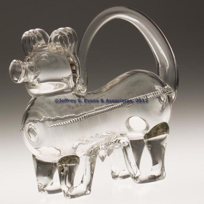 FREE-BLOWN ZOOMORPHIC DECANTER: FREE-BLOWN ZOOMORPHIC DECANTER, colorless, hollow body and head with applied appendages and rigaree, rough pontil mark on front. 19th or 20th century. 7 3/4" H, 8 3/4" L. Provenance: Collection of Geo