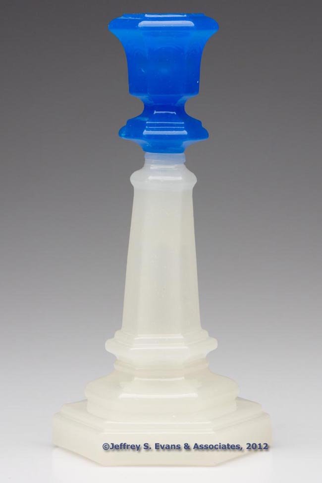 PRESSED HEXAGONAL CANDLESTICK: PRESSED HEXAGONAL CANDLESTICK, shiny translucent blue above alabaster/clambroth, standard size, nearly flat-top socket with a bladed-knop extension, raised on a tapered standard with lower knop and do