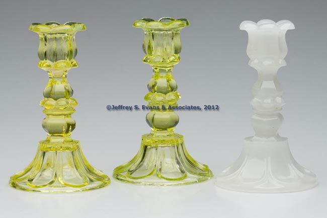 PRESSED PETAL AND LOOP CANDLESTICKS, LOT OF THREE: PRESSED PETAL AND LOOP CANDLESTICKS, LOT OF THREE, comprising two vaseline and a single alabaster/clambroth, each six-petal socket with a hexagonal extension, raised on a hexagonal knop and seven-loop