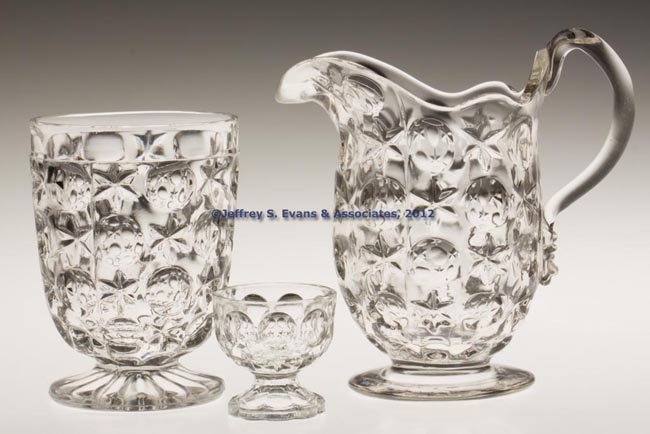 PRESSED EARLY MOON AND STAR ARTICLES, LOT OF THREE: PRESSED EARLY MOON AND STAR ARTICLES, LOT OF THREE, colorless lead glass, comprising a creamer with applied handle and polished pontil mark, a footed tumbler, and an individual salt. Boston & Sandwich
