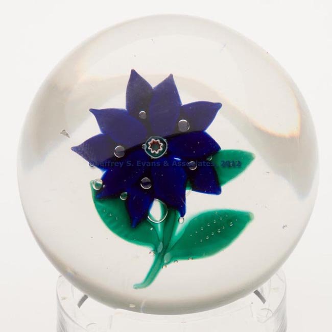 NEW ENGLAND POINSETTIA PAPERWEIGHT: NEW ENGLAND POINSETTIA PAPERWEIGHT, ten-petal flower with three green leaves and a stem, dew-like controlled bubbles, concave base with a polished pontil mark. New England Glass Co. or Boston & Sandwi