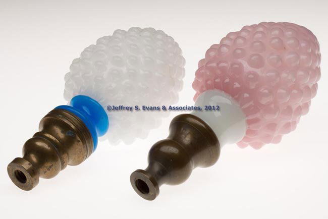 BLOWN-MOLDED OVAL HOBNAIL FINIALS, LOT OF TWO: BLOWN-MOLDED OVAL HOBNAIL FINIALS, LOT OF TWO, alabaster/clambroth with starch blue stem and pink over clambroth/alabaster with clambroth/alabaster stem, each of egg-shape with factory polished domed