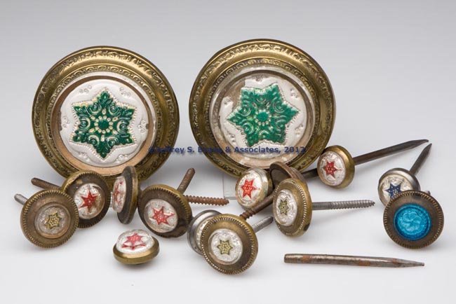 ASSORTED PRESSED-GLASS FACE PINS / NAILS: ASSORTED PRESSED-GLASS FACE PINS / NAILS, comprising a pair of curtain pins and 13 various picture nails, some matching, each colorless glass face filled with plaster of paris imitating sulphide, moun