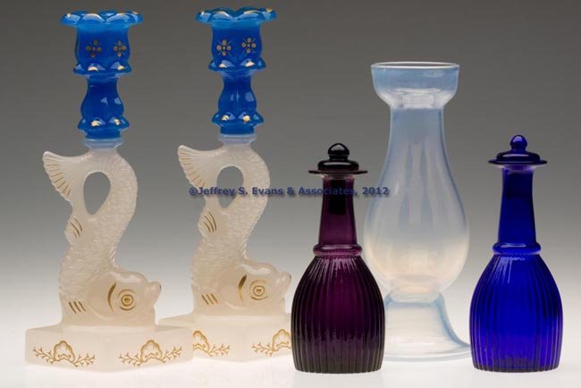 ASSORTED REPRODUCTION ARTICLES, LOT OF FIVE: ASSORTED REPRODUCTION ARTICLES, LOT OF FIVE, comprising a pair of Dolphin candlesticks, two cruet bottles marked for Pairpoint, and a hyacinth vase. Second half 20th century. 6 3/4" to 10 1/2" H. Prov