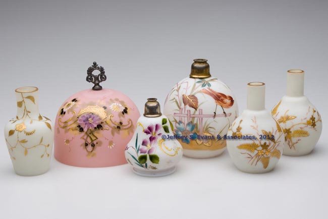 VICTORIAN DECORATED GLASS ARTICLES, LOT OF SIX: VICTORIAN DECORATED GLASS ARTICLES, LOT OF SIX, various opaque and translucent colors with polychrome decoration, comprising a pink butter cover with Britannia finial, two atomizer bases, and three va