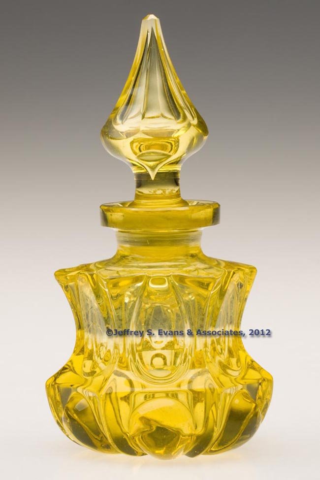 BLOWN-MOLDED ALMOND OVALS COLOGNE BOTTLE: BLOWN-MOLDED ALMOND OVALS COLOGNE BOTTLE, canary yellow, low, waisted hexagonal form with a short neck, factory polished thick flanged lip and pontil mark, original hexagonal panel-cut air-trap stoppe