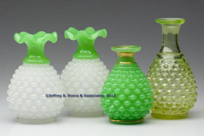 BLOWN-MOLDED OVAL HOBNAIL COLOGNE BOTTLES, LOT OF: BLOWN-MOLDED OVAL HOBNAIL COLOGNE BOTTLES, LOT OF FOUR, comprising a pair of jade green above alabaster/clambroth examples, and single vaseline and jade green examples, lacking stoppers. Boston & Sand