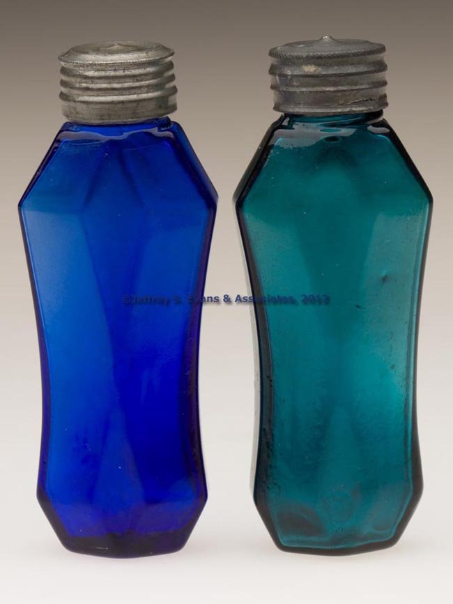 BLOWN-MOLDED COMMERCIAL PUNGENTS, LOT OF TWO: BLOWN-MOLDED COMMERCIAL PUNGENTS, LOT OF TWO, dull blue-green and bright sapphire blue, each slender polygon coffin form with long concave sides, threaded neck, and Britannia cap, one with cork liner.