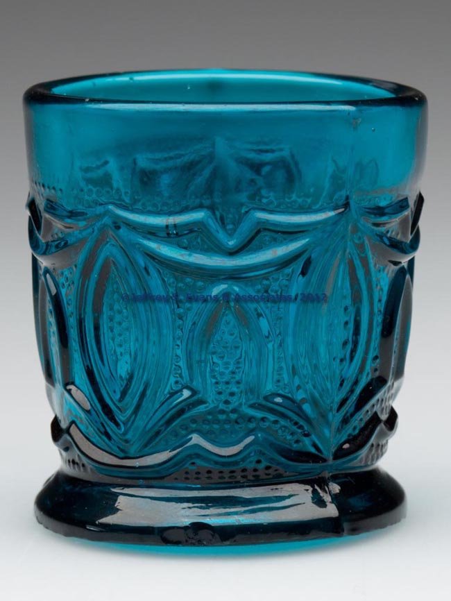 PRESSED LACY POINTED OVAL TOY TUMBLER: PRESSED LACY POINTED OVAL TOY TUMBLER, brilliant teal/peacock green, plain circular base with rough pontil mark. Boston & Sandwich Glass Co. 1830-1850. 1 3/4" H, 1 5/8" D rim. Literature: Parallels B 
