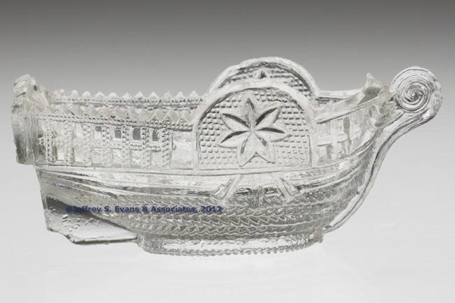 BT-2 "PITTSBURGH." STEAMBOAT PRESSED SALT: BT-2 "PITTSBURGH." STEAMBOAT PRESSED SALT, colorless, embossed on stern, rope table ring. Rare. Stourbridge Flint Glass Works. 1830-1845. 1 1/2" H, 1 7/8" x 3 5/8". Literature: Neal, p. 21. Elsholz, l
