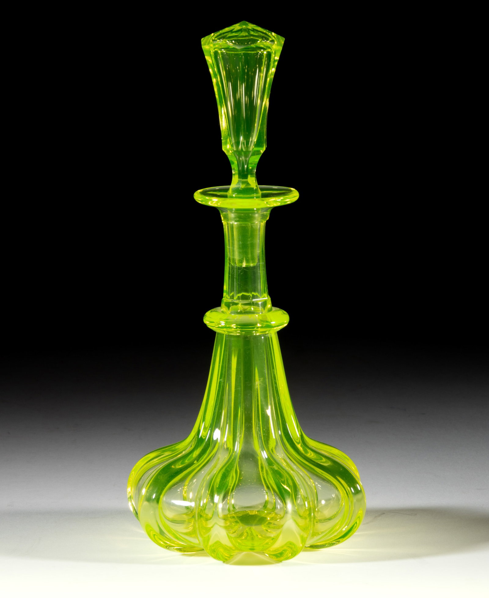 PILLAR-MOLDED COLOGNE BOTTLE: PILLAR-MOLDED COLOGNE BOTTLE, canary yellow (reacts under black light), squat form with eight wide, pronounced ribs, panel-cut neck with lower applied convex ring, and a wide factory-polished flanged 