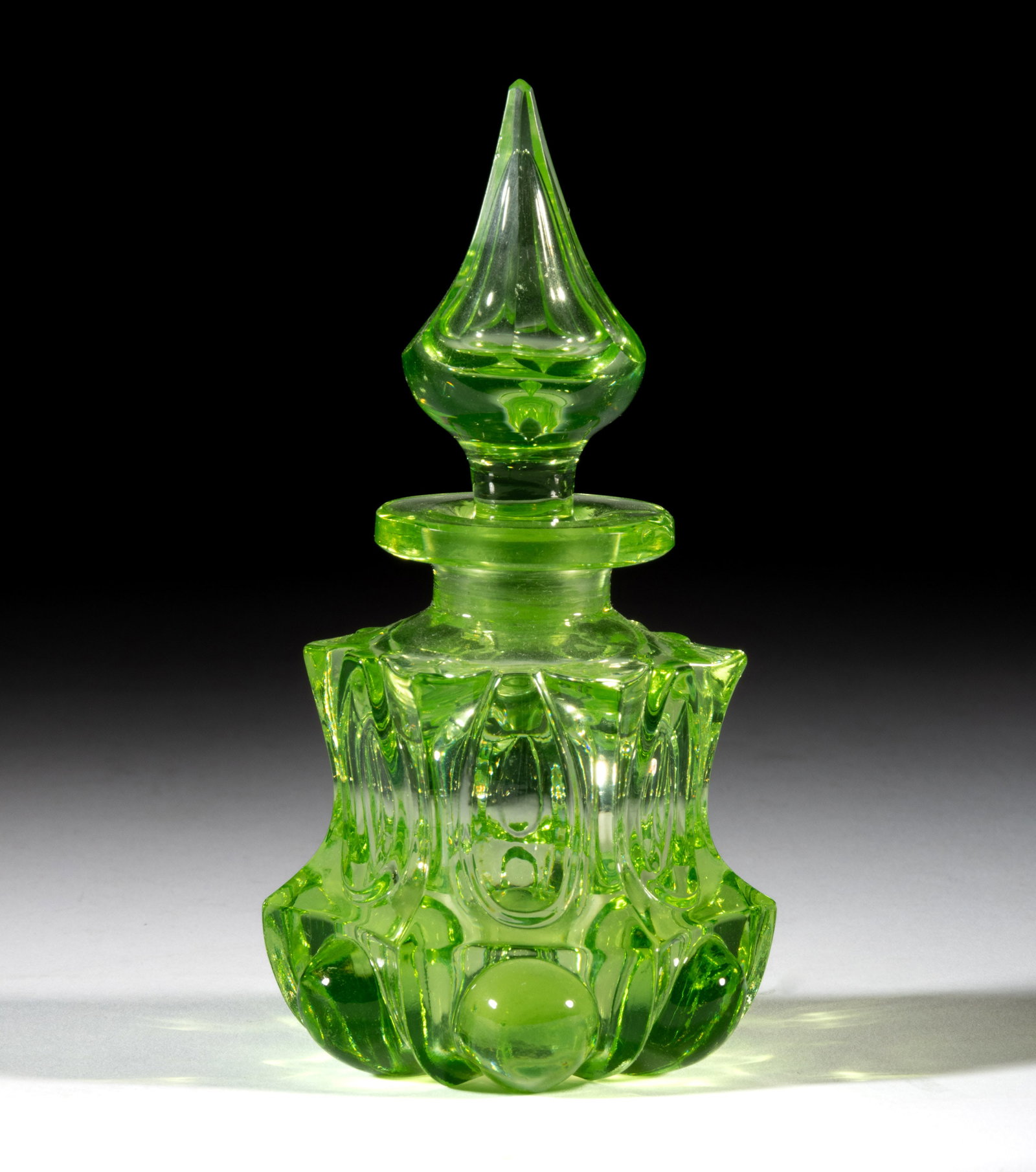 LOOP AND FRAMED CONVEX OVALS COLOGNE BOTTLE: LOOP AND FRAMED CONVEX OVALS COLOGNE BOTTLE, apple green (reacts under black light), low, waisted hexagonal form with a short neck, thick flanged mouth, and polished base, original hexagonal flut