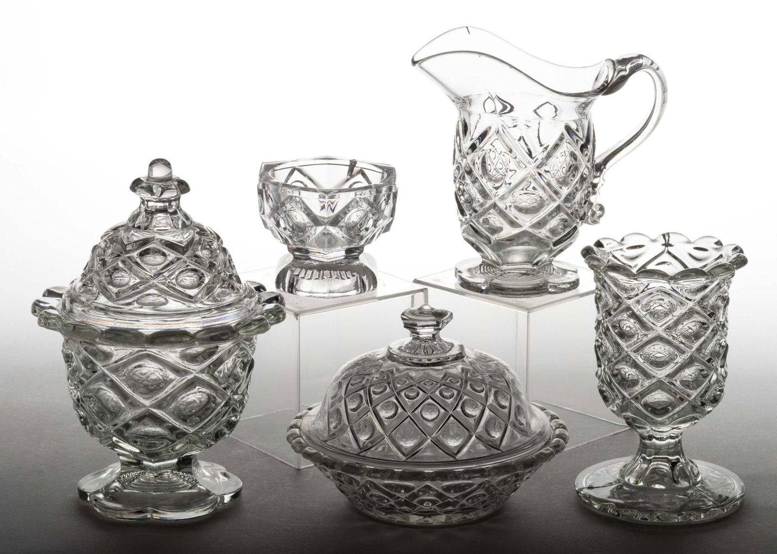 DIAMOND THUMBPRINT TABLE ARTICLES, LOT OF FIVE: DIAMOND THUMBPRINT TABLE ARTICLES, LOT OF FIVE, colorless lead glass, comprising a covered sugar bowl, covered butter dish, creamer, spooner, and master open salt. Boston & Sandwich Glass Co. and